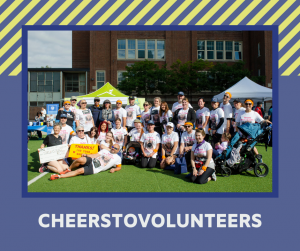 Image of big group posing for a photo, on purple background with green shapes and text that reads "Cheers to Volunteers"