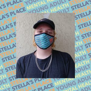 Photo of person wearing Stella's Place mask, blue patterned background