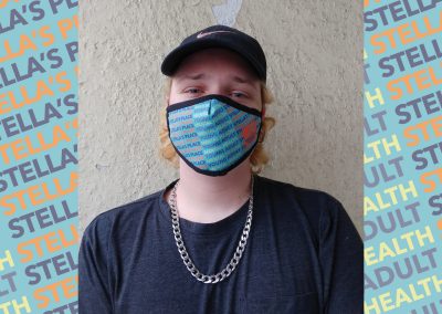 Photo of person wearing Stella's Place mask, blue patterned background