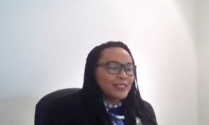 A screenshot of Wangari speaking at the Review & Reimagine Panel Event