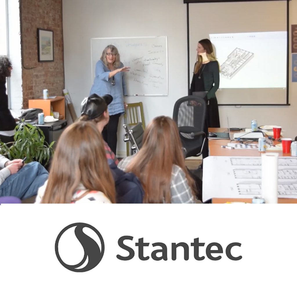 A photo of a bunch of people in a room looking towards the front at someone speaking with the Stantec logo at the bottom in black