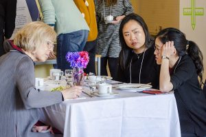 A photo of 3 people sitting at a table at a corporate event. From left to right is Dagmar Schroeder, Bora Han and Shannon Gong.