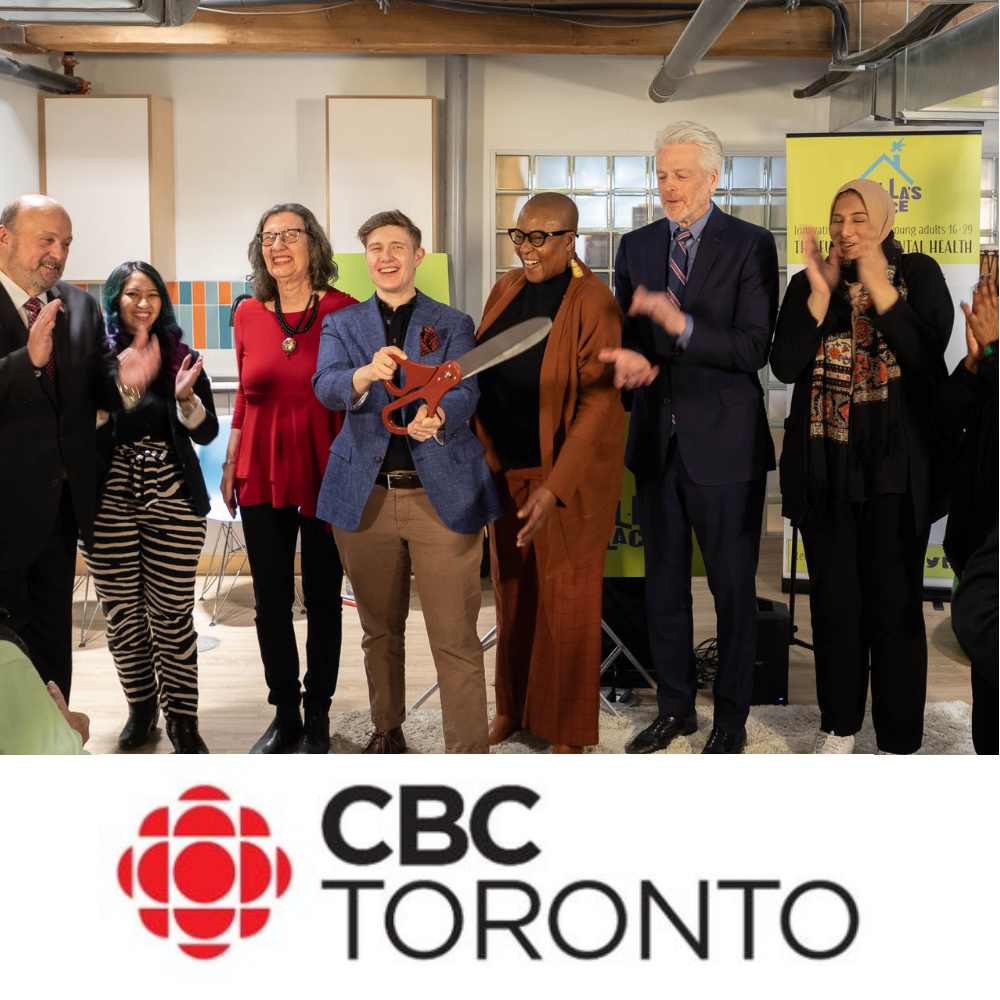 A photograph of a group of people cutting a red ribbon with large scissors in Stella's Place new Facility, with the CBC Toronto logo below