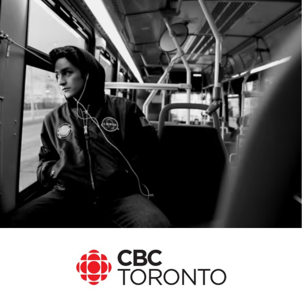 A black and white graphic of a young person sitting on a bus looking out the window, with the CBC Toronto logo underneath